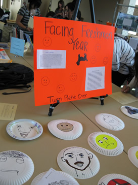 Poster explains that one side of each paper plate shows a facial expression; the other, an explanation of the emotion depicted.