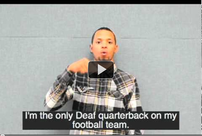 You Tube video image of a boy signing that he is the only Deaf quarterback on his football team.